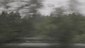 Blurred scenery from a train window showing forest and passing cars, motion blur effect - Powered by Shutterstock - Get 15% off with code: PIKWIZARD15