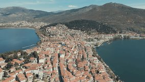 Drone EPIC FLIGHT above a historic village on a hill in Europe, red roof tops, little houses, sunny weather, blue water lake, SCENIC mountains, Greece 4K video