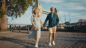 Happy senior couple spending time together in London city. Beautiful woman and man walking and having fun near the thames river. Concepts about seniority, lifestyle and travel
 - Powered by Shutterstock - Get 15% off with code: PIKWIZARD15