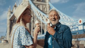 Happy senior couple spending time together in London city. Beautiful woman and man eating ice cream on the thames river. Concepts about seniority, lifestyle and travel
 - Powered by Shutterstock - Get 15% off with code: PIKWIZARD15
