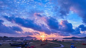 
time lapse clouds moving in colorful sky at twilight above fishing port in Rawai beach Phuket. 
Nature video High quality footage.
Scene of Colorful sky sunset with cloud background.