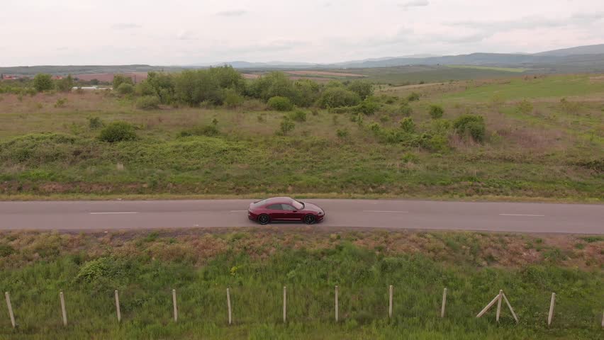 Sports red car driving down the road