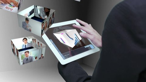Businesswoman using tablet to view montage of business people at work in holographic form