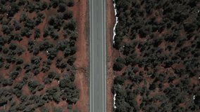 Aerial view of black car driving on interstate highway in Utah, USA.