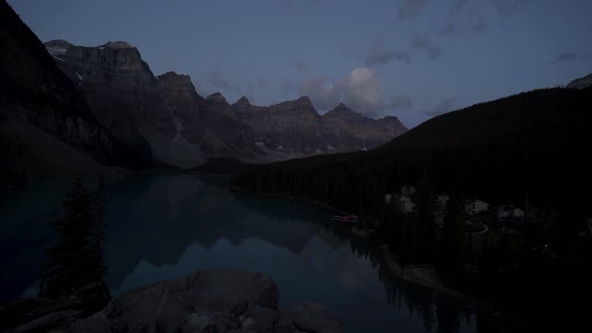 Moraine Lake is a Canadian glacial lake located in Banff National Park in Alberta. Sunrise at the lake. Moraine lake timelapse. Dense fir forests. Lakes in Canada. Extremely beautiful nature.
