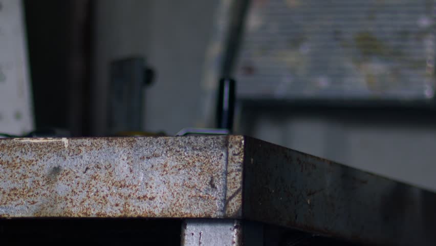 Hand using old vintage tools in workshop wide zoom shot selective focus