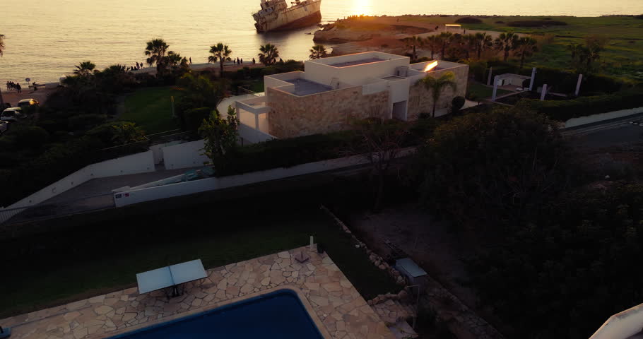 Aerial view of a sunken ship in Paphos on the island of Cyprus. Sunset tourist spot on the seashore. High quality 4k footage
