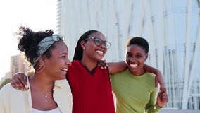 Group of three excited young African American women running embraced and having fun together enjoying leisure time in city street outdoors. Black beautiful friends celebrating friendship. Slow motion - Powered by Shutterstock - Get 15% off with code: PIKWIZARD15