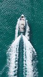 Vertical Screen: From A High Vantage Point, This Image Captures A Solitary Speedboat Racing Through The Deep Azure Waters Of Hawaii, Its Wake Marking The Ocean's Surface. 