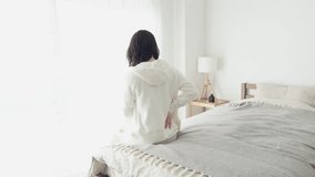 A woman caring about her painful lower back - Powered by Shutterstock - Get 15% off with code: PIKWIZARD15