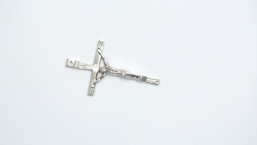 Silver crucifix on white background