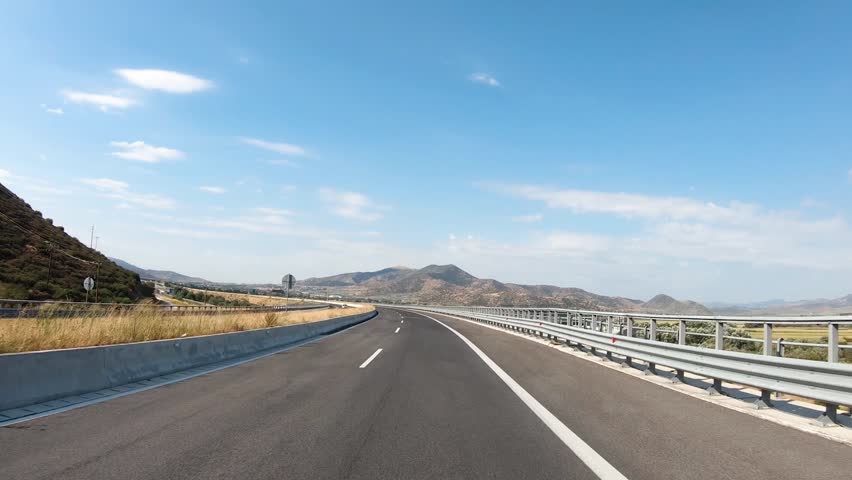 Slow motion road trip on Europe, first-person view of a moving car on a highway, summer mountains natural landscape.