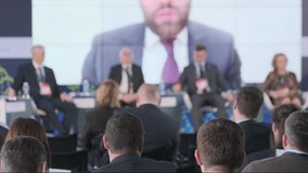 Focused audience at an international conference listening to speakers discussing global issues, with a blurred forefront and sharp background. - Powered by Shutterstock - Get 15% off with code: PIKWIZARD15