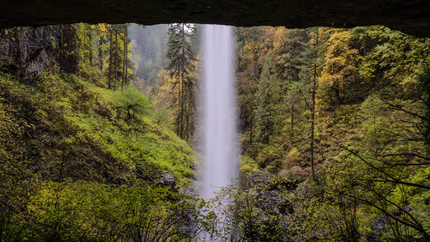 Time lapse of Water fall with clear water seen from the cave in United States