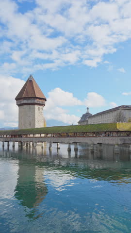 Scenic of Historic city center with famous Chapel Bridge and lake Lucerne on a morning cloudy day and blue sky, Canton of Lucerne, Switzerland. Tourist destination in autumn. Vertical mobile screen. Royalty-Free Stock Footage #3503577091
