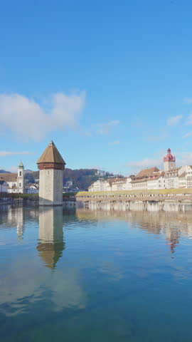 Scenic of Historic city center with famous Chapel Bridge and lake Lucerne on a morning cloudy day and blue sky, Canton of Lucerne, Switzerland. Tourist destination in autumn. Vertical mobile screen. Royalty-Free Stock Footage #3503577253