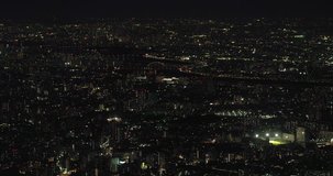 TOKYO, JAPAN – JUNE 2016 : Video shot over central Tokyo cityscape at night with river and tall buildings in view