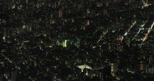 TOKYO, JAPAN – JUNE 2016 : Video shot over central Tokyo cityscape at night with tall buildings in view