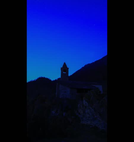 Star Trail over the chapel of San Romerio on cliff, Grisons, Switzerland