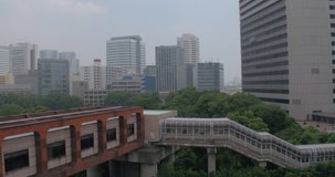 TOKYO, JAPAN – JUNE 2016 : Video shot of subway stairs from a train with park and tall buildings in view