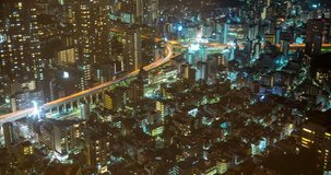 TOKYO, JAPAN – JUNE 2016 : Timelapse of downtown Tokyo at night with cityscape and traffic junction in view from Tokyo Tower