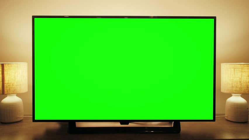 LcD smart TV screen with a blank green background in the living room. Chroma key screen for advertising.