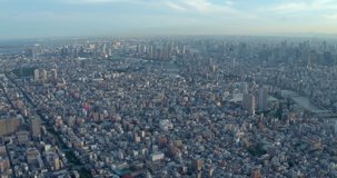 TOKYO, JAPAN – JUNE 2016 : Video shot over central Tokyo cityscape on a sunny day with river and tall buildings in view