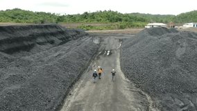 Workers are monitoring the coal mining industrial area, video taken using an aerial drone