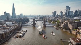 Aerial view of the Tower Bridge of London, England, lifted open with passenger ship traffic on the river Thames - Powered by Shutterstock - Get 15% off with code: PIKWIZARD15