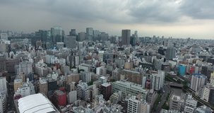 TOKYO, JAPAN – JUNE 2016 : Aerial shot over Tokyo Harbour area and central cityscape on a cloudy day
