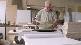 A grandfather teaches his grandson how to fix furniture in his carpenter workshop. They work together, sharing tools and skills, as the grandfather passes on his knowledge. - Powered by Shutterstock - Get 15% off with code: PIKWIZARD15