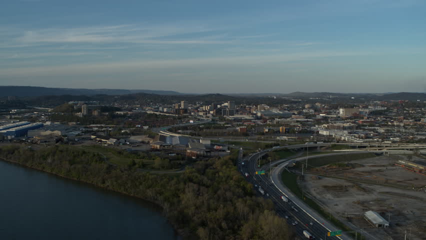 Wide aerial footage of downtown Chattanooga with highway 27 and merging into highway 24 during the sunset.