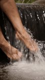 Woman's feet cooling off in cold water