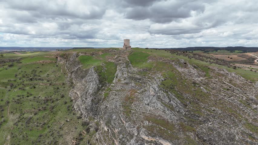 Aerial drone approaching view of a medieval watch tower in Burgo de Osma, Soria, Spain, in the top of a hill. 4k 60FPS