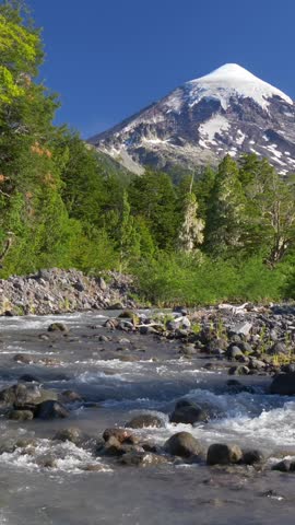 Lanin volcano in Lanin national park. Landscape with volcano, mountain river and green trees. Argentina, Patagonia, Lake district. Vertical video