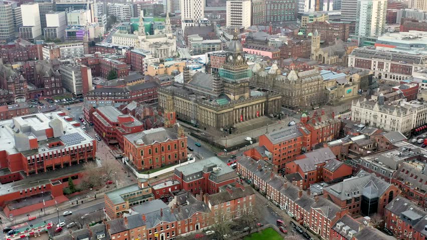 Leeds Town Hall aerial footage over looking the whole of the Leeds City Centre in West Yorkshire in the UK and showing the Leeds Town Hall historical building and  local businesses in the town.