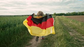 German little boy runs with Deutschland national flag. Patriotism. Black, red and yellow colors of Germany. Happy future.  - Powered by Shutterstock - Get 15% off with code: PIKWIZARD15