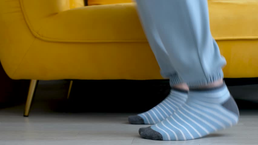 Male legs jumping close-up side view, home workout concept.