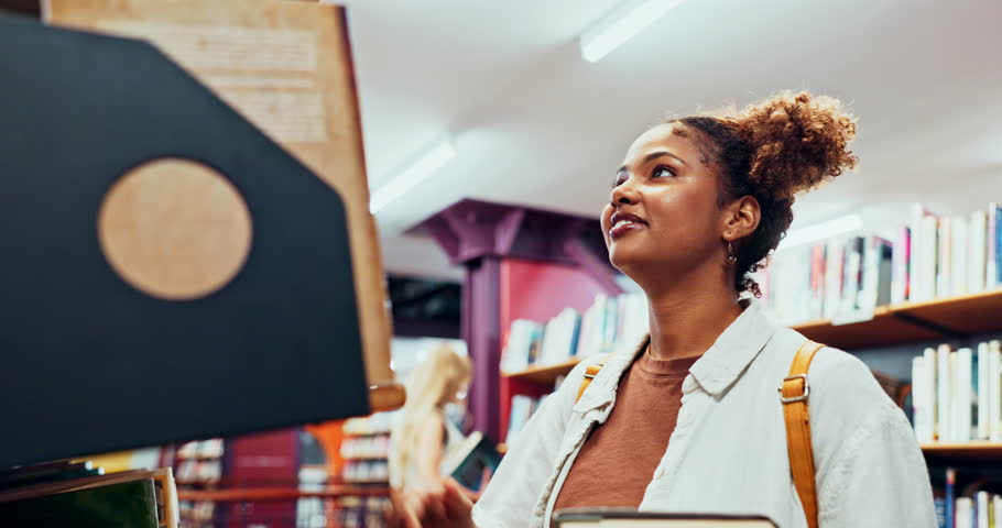 Black girl, student and choice of book in library for reading or learning, education and research knowledge for college assignment. Woman, bookshelf and check for literature textbook for essay task.