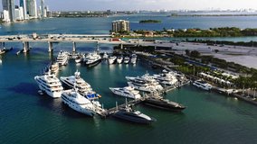 4k view from above on the island with yachts at marina harbor. Beautiful slow motion drone video for yacht business. Ideal commercial footage for water sport, sailing or transportation business. Miami
