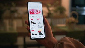 Shopping online for shoes using smartphone retail app. Sale with great discounts and special offers. Scrolling through a catalog of shoes. Fictional interface. - Powered by Shutterstock - Get 15% off with code: PIKWIZARD15