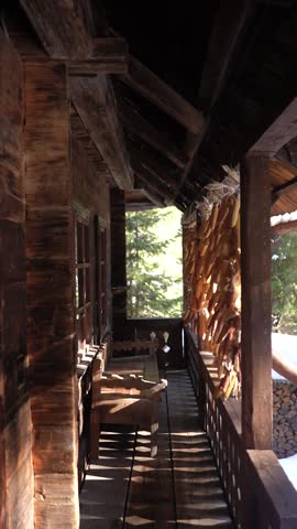 wooden house made of wood and hay in a village high in the mountains, spring sun and outdoor weather in the forest