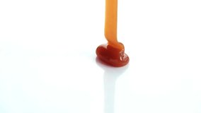 Super Slow Motion Shot of Rippling Melted Caramel Super Slow Motion Shot of Salted Caramel Explosion Towards Camera Isolated on Black Dripping caramel drops of sweet caramel sauce.  - Powered by Shutterstock - Get 15% off with code: PIKWIZARD15