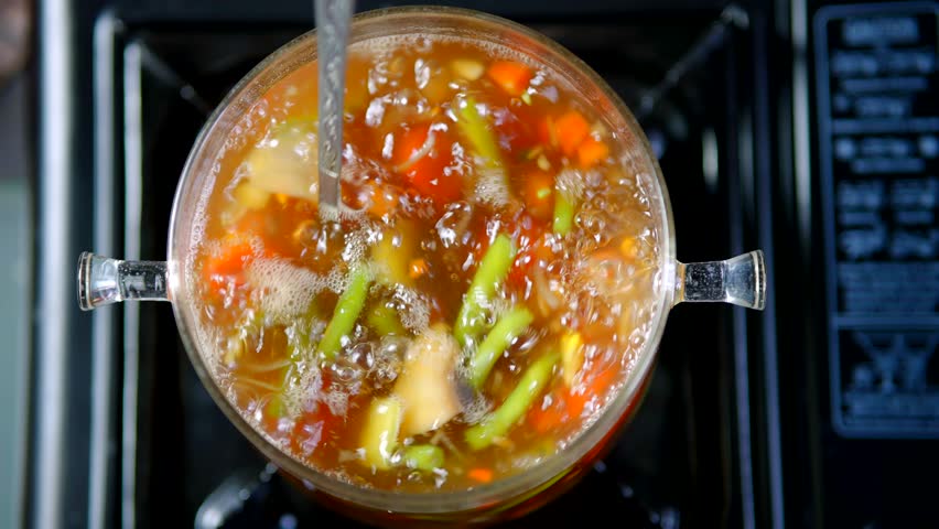 Stirring Pot Of Chicken Soup. Hot Dish Lunch Traditional Italian Dinner Meal. Minestrone Gourmet Dish. Stirring Boiling Pot Hot Chicken Soup. Vegetables Soup On Stove. Vegetarian Meal On Dieting
