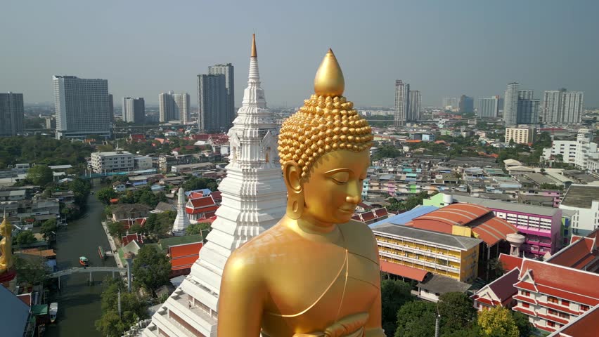 Aerial view of the Giant Golden Buddha in Bangkok and a city skyline