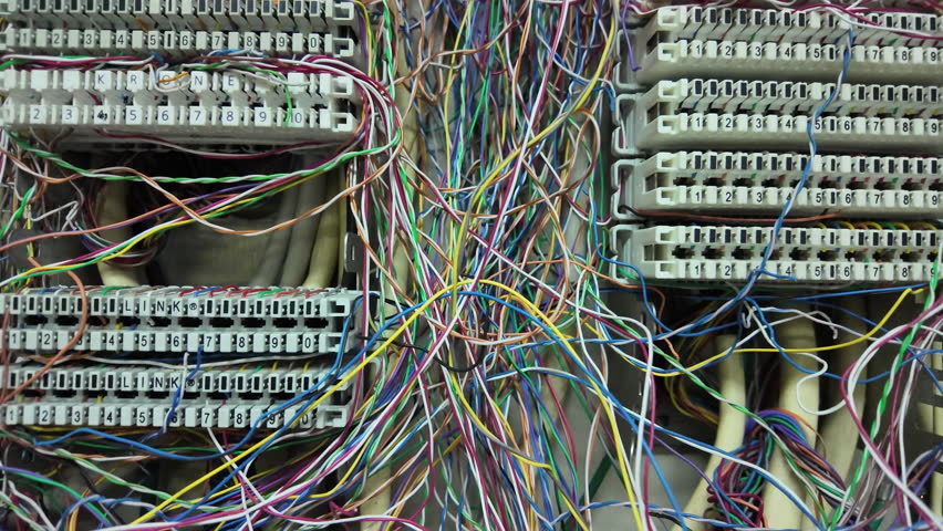 Inside a PABX telephone booth that has a number of connecting cables in many colors in the analog system. communication technology