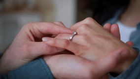 Unrecognizable boyfriend male guy man put luxury ring jewelry on female hand finger at home love marriage romantic woman girl husband wife bridal bride celebration ceremony couple engagement at home - Powered by Shutterstock - Get 15% off with code: PIKWIZARD15