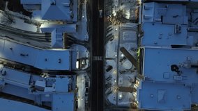Snow covered town houses lining main street with quaint Christmas decorations and lights. Top down aerial at night. - Powered by Shutterstock - Get 15% off with code: PIKWIZARD15