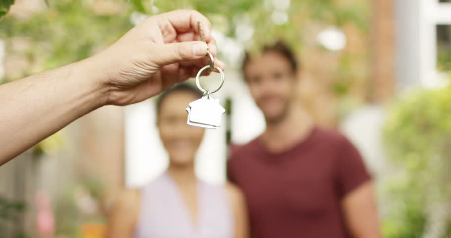 4K Portrait happy couple in front of new home, taking the key from estate agent. Slow motion. | Shutterstock HD Video #35044183