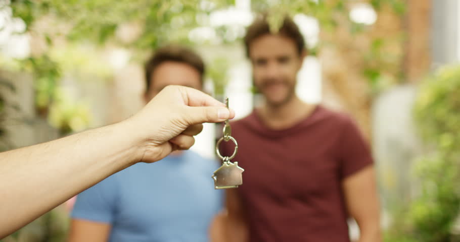 4K Happy gay couple in front of new home, taking key from real estate agent & sharing a kiss. Slow motion. | Shutterstock HD Video #35044192